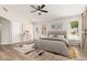 Relaxing main bedroom with wood floors, neutral walls, ceiling fan, and sliding barn door at 20961 N 96Th Dr, Peoria, AZ 85382