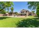 Expansive backyard with lush lawn, a swimming pool, and patio area, perfect for outdoor entertaining at 2438 S Chestnut Pl, Chandler, AZ 85286