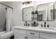 Bathroom featuring double sinks, modern fixtures, and decorative plants at 2438 S Chestnut Pl, Chandler, AZ 85286