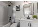 Elegant bathroom features a shower/tub combo, modern fixtures, and a stylish mirror at 2438 S Chestnut Pl, Chandler, AZ 85286
