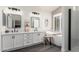 Modern bathroom with double sinks, a soaking tub, walk-in shower, and sleek black fixtures at 2438 S Chestnut Pl, Chandler, AZ 85286