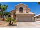 Charming two-story home featuring a well-manicured front yard, covered entryway, and attached two-car garage at 2438 S Chestnut Pl, Chandler, AZ 85286