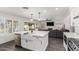 Open-concept kitchen with a large island, stainless steel appliances, and a view of the backyard at 2438 S Chestnut Pl, Chandler, AZ 85286