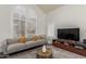 Inviting living room with high ceilings, modern furniture, and a large window offering plenty of natural light at 2438 S Chestnut Pl, Chandler, AZ 85286