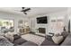 Cozy living room featuring a fireplace, large sectional sofa, and an abundance of natural light at 2438 S Chestnut Pl, Chandler, AZ 85286