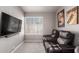 Home theater room boasts comfortable seating and a large screen TV for entertainment at 2438 S Chestnut Pl, Chandler, AZ 85286