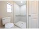Bright bathroom featuring tile shower with grab bars and a comfort height toilet at 2650 W Union Hills Dr # 169, Phoenix, AZ 85027