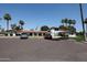 View of community center with red tile roof, ample parking, and desert landscaping at 2650 W Union Hills Dr # 169, Phoenix, AZ 85027