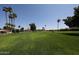 Green community space with palm trees, mature trees and park benches in the background at 2650 W Union Hills Dr # 169, Phoenix, AZ 85027