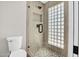 Updated shower featuring glass enclosure, stylish showerhead, and decorative tile at 2801 E Sunnyside Dr, Phoenix, AZ 85028