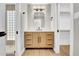 Bathroom featuring a wooden vanity with dual sinks, modern lighting, and a glass shower at 2801 E Sunnyside Dr, Phoenix, AZ 85028