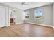 Spacious bedroom with two windows, a ceiling fan, and an en-suite bathroom at 2801 E Sunnyside Dr, Phoenix, AZ 85028