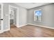 Bright bedroom featuring wood flooring, light walls, a view of blue sky, and an en-suite bathroom at 2801 E Sunnyside Dr, Phoenix, AZ 85028