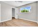 Bedroom featuring light walls, a large window, wood flooring, and a closet at 2801 E Sunnyside Dr, Phoenix, AZ 85028