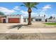 Charming single-story home with a modern design and a well-maintained yard and a wood garage door at 2801 E Sunnyside Dr, Phoenix, AZ 85028