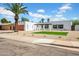 Modern home featuring desert landscaping and a wooden garage door at 2801 E Sunnyside Dr, Phoenix, AZ 85028