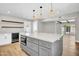 Bright kitchen features a large island with a marble countertop, stainless steel appliances, and modern lighting at 2801 E Sunnyside Dr, Phoenix, AZ 85028