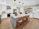 Contemporary kitchen featuring stainless steel appliances, a spacious island, and modern lighting fixtures at 2801 E Sunnyside Dr, Phoenix, AZ 85028