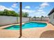 Backyard swimming pool and pool deck area with mature landscaping and blue skies at 2801 E Sunnyside Dr, Phoenix, AZ 85028