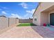 Spacious backyard featuring pavers, artificial grass, and block wall at 2898 E Kim Dr, San Tan Valley, AZ 85143