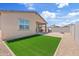 A private backyard with a well-manicured lawn, a patio, and a built-in fire pit, perfect for outdoor entertaining at 2898 E Kim Dr, San Tan Valley, AZ 85143