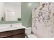 Cozy bathroom with single sink, dark wood cabinet, and stylish shower curtain against a fresh green wall at 2898 E Kim Dr, San Tan Valley, AZ 85143