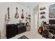 This music themed room includes several guitars mounted to the wall and music equipment on the carpeted floor at 2898 E Kim Dr, San Tan Valley, AZ 85143