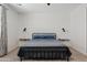 Bright bedroom featuring a modern black metal bed frame, neutral carpet, and ample natural light from a window at 2898 E Kim Dr, San Tan Valley, AZ 85143