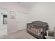 Charming Bedroom with neutral paint, a gray crib, and closet; perfect for creating a serene space for your little one at 2898 E Kim Dr, San Tan Valley, AZ 85143