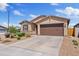 Inviting single-story home boasting a well-maintained lawn, two-car garage, and appealing facade at 2898 E Kim Dr, San Tan Valley, AZ 85143