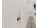 Bright hallway with a decorative rug, white walls with wainscoting, and neutral flooring at 2898 E Kim Dr, San Tan Valley, AZ 85143