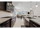 Contemporary kitchen with stainless steel appliances, a subway tile backsplash, and a view into the living area at 2898 E Kim Dr, San Tan Valley, AZ 85143