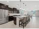 Modern open-concept kitchen with stainless steel appliances, granite countertops, and an island with bar stools at 2898 E Kim Dr, San Tan Valley, AZ 85143
