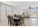 Open-concept dining and living area featuring tile flooring, a dark wood table, and comfortable seating at 2898 E Kim Dr, San Tan Valley, AZ 85143