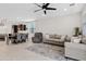 Spacious living room featuring tile floors, contemporary furnishings, and an open concept design to the kitchen and dining area at 2898 E Kim Dr, San Tan Valley, AZ 85143