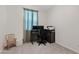Bright office featuring a modern desk setup, neutral carpet, and ample natural light from a window at 2898 E Kim Dr, San Tan Valley, AZ 85143