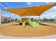 Community playground with green slide, climbing area, and overhead shade cover at 2898 E Kim Dr, San Tan Valley, AZ 85143