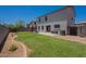 Large grassy backyard with a concrete patio, perfect for outdoor entertaining and relaxation at 3047 S Mandy St, Mesa, AZ 85212