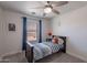 Cozy bedroom with a wood bed frame, ceiling fan, natural light, and a cute decorative moose at 3047 S Mandy St, Mesa, AZ 85212