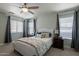 Comfortable bedroom with neutral walls, plush carpet, a ceiling fan, and large windows with natural light at 3047 S Mandy St, Mesa, AZ 85212