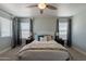 Comfortable bedroom with neutral walls, plush carpet, a ceiling fan, and large windows with natural light at 3047 S Mandy St, Mesa, AZ 85212