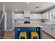 Bright kitchen features a butcher block island with seating, stainless appliances and sleek white cabinetry at 3047 S Mandy St, Mesa, AZ 85212