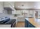 Modern kitchen with stainless steel appliances, white cabinets and a charming island with a wooden countertop at 3047 S Mandy St, Mesa, AZ 85212
