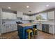 Well-lit kitchen with stainless steel appliances, white cabinets, butcher block island, and stylish backsplash at 3047 S Mandy St, Mesa, AZ 85212