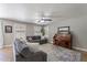 Comfortable living room featuring a ceiling fan, couch, piano, and large windows at 3047 S Mandy St, Mesa, AZ 85212
