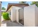 View of a home's white exterior walls and gated entrance, providing privacy and security at 3324 S Parkside Dr, Tempe, AZ 85282