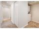 Hallway with a laundry closet with a stackable washer and dryer set and a carpeted floor at 3324 S Parkside Dr, Tempe, AZ 85282