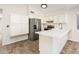 Well lit kitchen featuring stainless steel appliances, a breakfast bar and light colored cabinets at 3324 S Parkside Dr, Tempe, AZ 85282