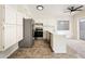 Well lit kitchen featuring stainless steel appliances, a breakfast bar, light colored cabinets and fan at 3324 S Parkside Dr, Tempe, AZ 85282