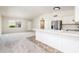 Open concept living space featuring kitchen with breakfast bar and living room with lots of light at 3324 S Parkside Dr, Tempe, AZ 85282
